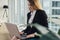 Young female copywriter writing an advertising text typing on laptop keyboard sitting in office