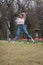 Young female dancer practicing jumps in the park