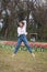 Young female dancer practicing jumps in the park