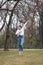 Young female dancer practicing jumps in the park