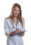 Young female doctor with blond hair and clipboard writing message