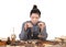 A young female doctor of Chinese medicine uses a medicine scale to weigh the medicine at the table full of various medicinal mater