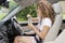 Young female driver drinking from a bottle of water