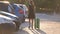 Young female driver loading luggage suitcase bag inside her car. Travelling and vacations concept