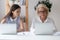 Young female employee peep in colleague laptop