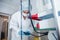 A young female endoscopist in a white protective suit, cap and gloves prepares the equipment for work.