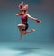 A young female fighter performs a jump kick.