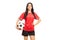 Young female football player holding a ball