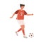 Young female football player running up to kick ball forward. Woman playing European soccer in red sports outfit, boots
