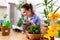 Young female gardener with plants indoors