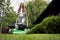 Young female gardener using lawn mower.