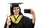 Young female graduated student taking selfie