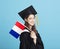 Young female graduation student showing the France flag