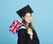 Young female graduation student showing the United Kingdom   flag