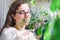 Young female in her personal greenhouse