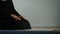 Young female in hijab praying on mat, asking god forgiveness, religious ritual