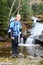 Young female hiker and river cascade