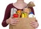 Young female holding brown eco friendly grocery bag with perishable foods