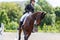 Young female horse rider on equestrian sport event