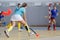 Young female indoor hockey player in attack