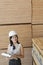 Young female industrial worker inspecting wooden planks