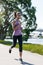 Young female jogger doing exercising outdoors