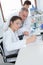 Young female lab worker on wheelchair