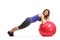 Young female leaning on a fitness ball and exercising