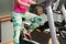 Young female legs training and riding the stationary bicycle