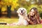 Young female lying down with her dog in a park