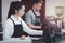 Young female and male  barista wearing apron standing behind coffee shop cashier counter, waitress and waiter staff working at