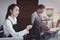 Young female and male  barista wearing apron standing behind coffee shop cashier counter, waitress and waiter staff working at