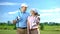 Young female and male with golf clubs hugging and smiling each other sport study