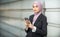 Young Female Muslim Entrepreneur looking serious, holding her smartphone.