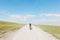 Young female nature explorer walking on a gravel road