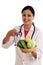 Young female nutritionist doctor holding bowl of vegetables