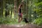 Young female obedience trainer  training her black labrador puppy