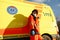 Young female paramedic posing near ambulance vehicle