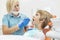 Young Female Pediatric Dentist Using a Mouth Mirror