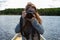 Young female photographer clicking pictures in canoe