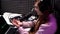 Young female podcaster speaking in modern studio