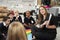 Young female primary school teacher reading a book to children sitting on the floor in a classroom, selective focus