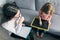 Young female psychologist talking with patient child girl in office. Mental health of children