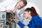 Young female repairman fixing computer