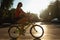 Young Female Riding Bike