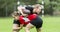 The young female rugby player on green backround