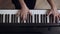 Young female`s pianist hands playing grand piano