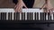 Young female`s pianist hands playing grand piano