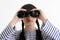 Young female sailor looking through binoculars