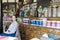 Young female sales assistant sitting down in Victorian Chemist/